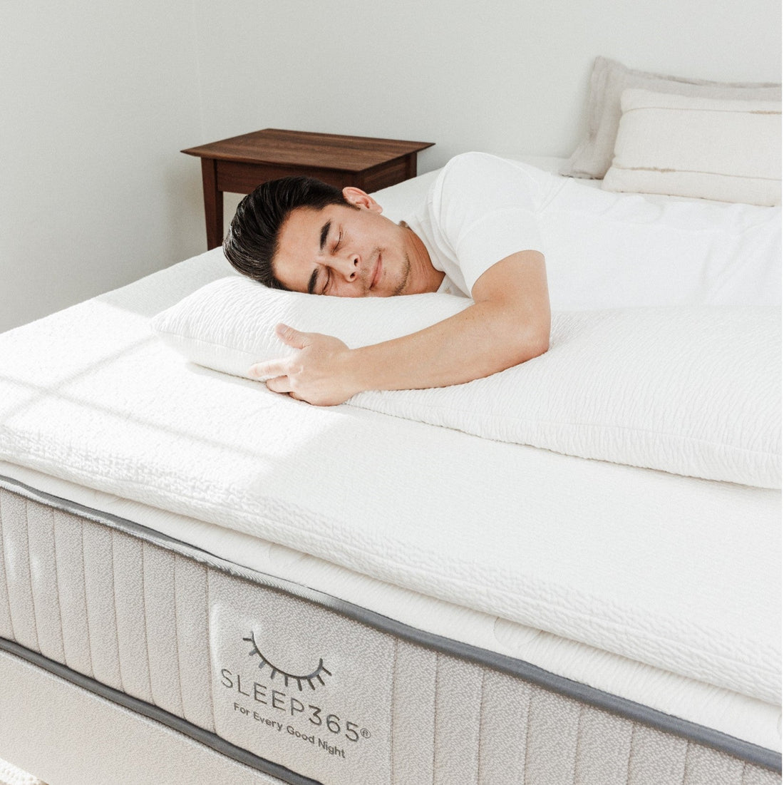 Close-up of a man sleeping on a plush organic latex mattress topper for pressure relief and comfort for side sleepers