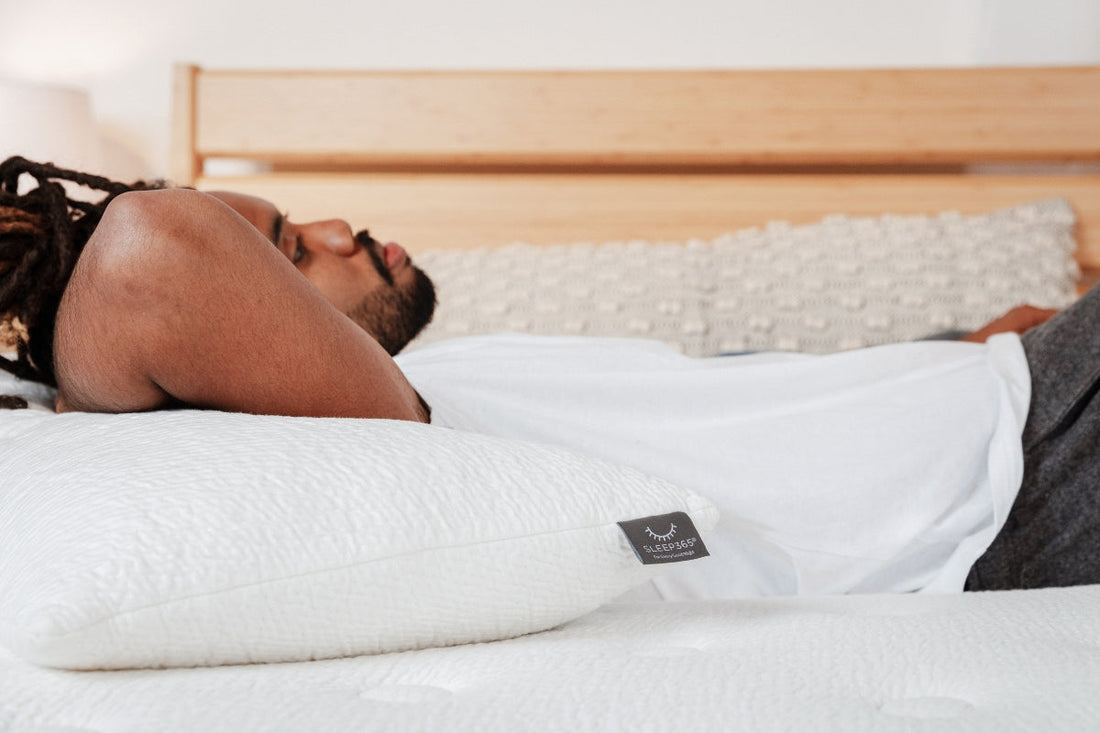 Person sleeping on back on a supportive mattress designed to keep spinal alignment and minimise lower back pressure.